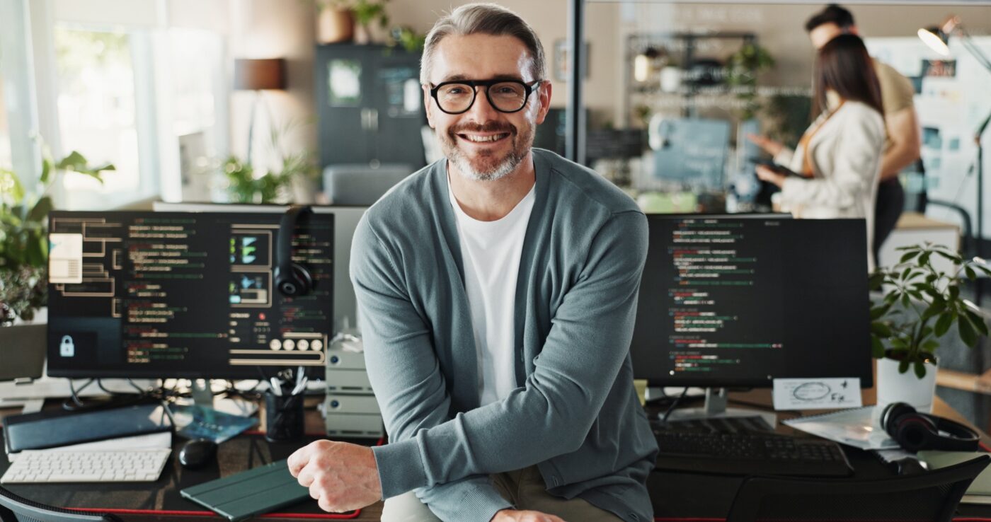 Happy man, coder and glasses in office for portrait, website development and software engineering o